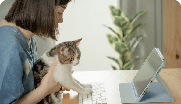 Woman on laptop with cat